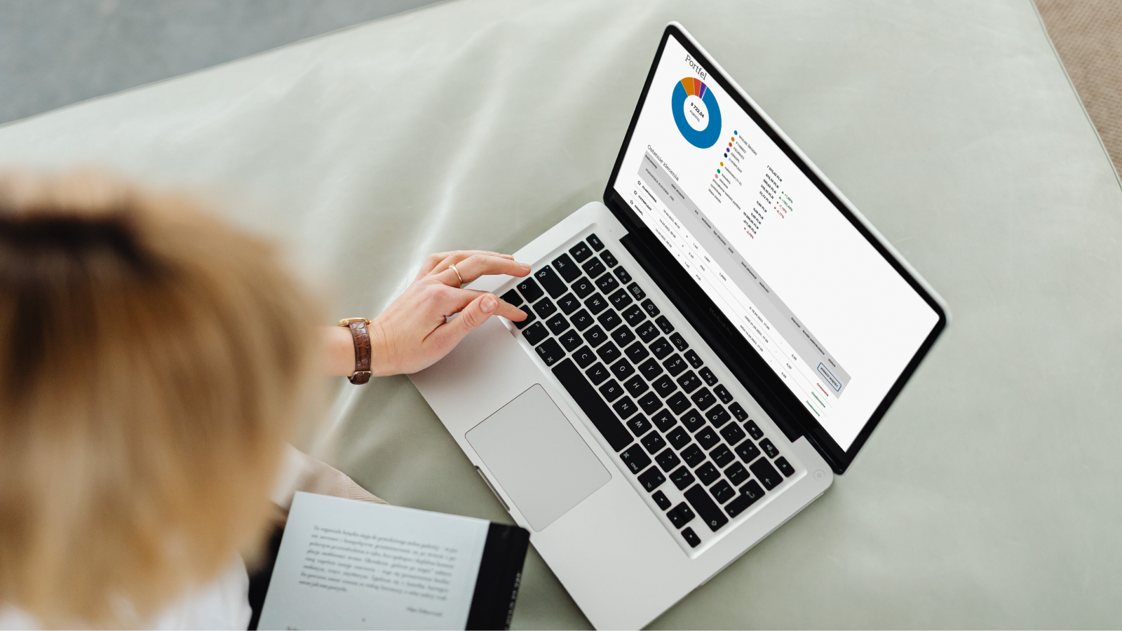 woman uses the stock market game from Warsaw stock exchange on the laptop, sees the first screen after logging in, that is, a visual representation on a pie chart of the distribution of funds and a table with the latest orders and their properties