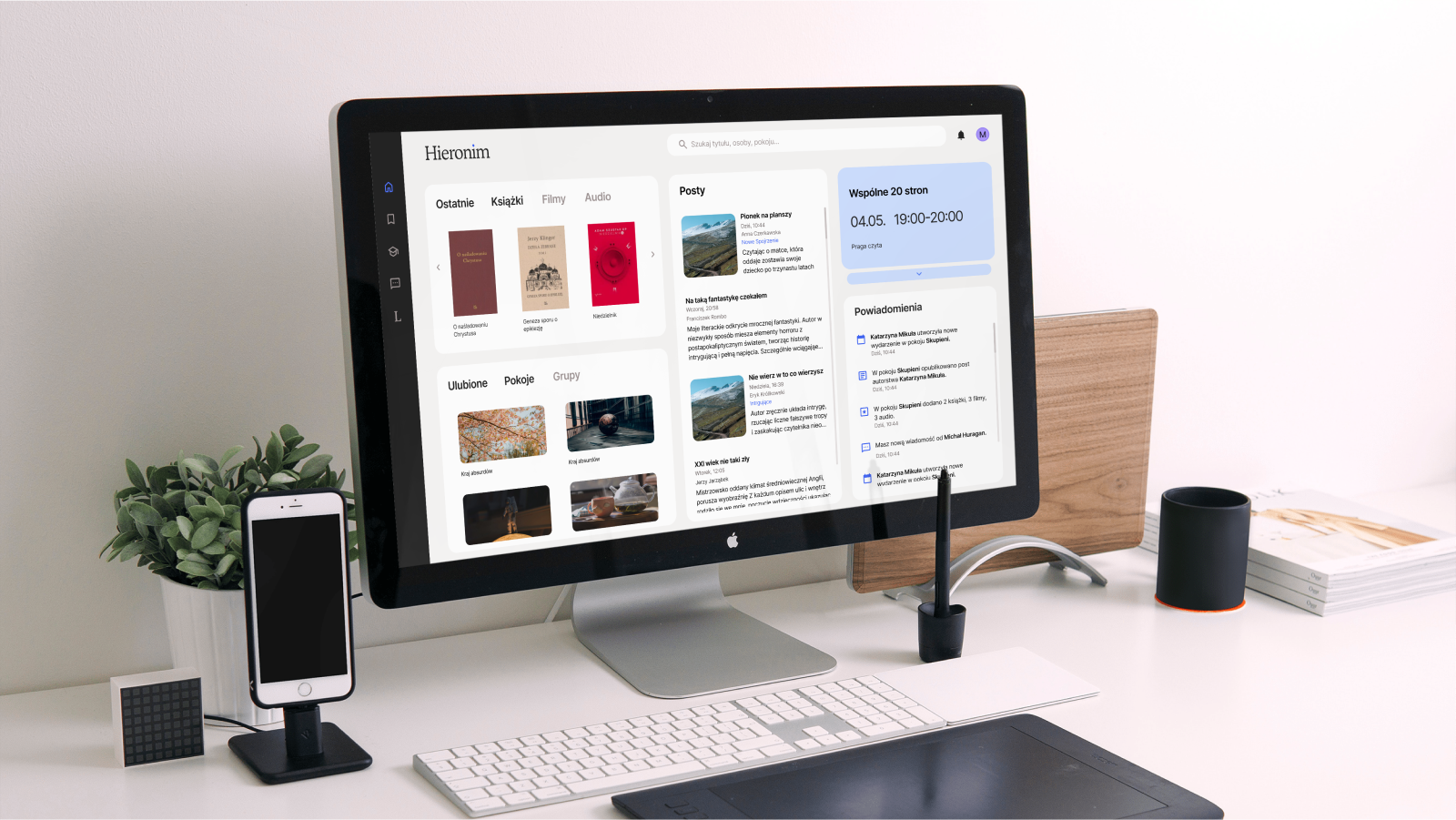 A computer screen on a desktop with the design of the main page of the user's Hieronymus multimedia library displayed. Shown are recent books, movies, audiobooks, favorite groups, a feed with posts from groups, a calendar of group events, and notifications with recent events on the site. The look is bright, neat, rounded panels have tabs . They subtly stand out from the background, making it easy to scan the page. 
