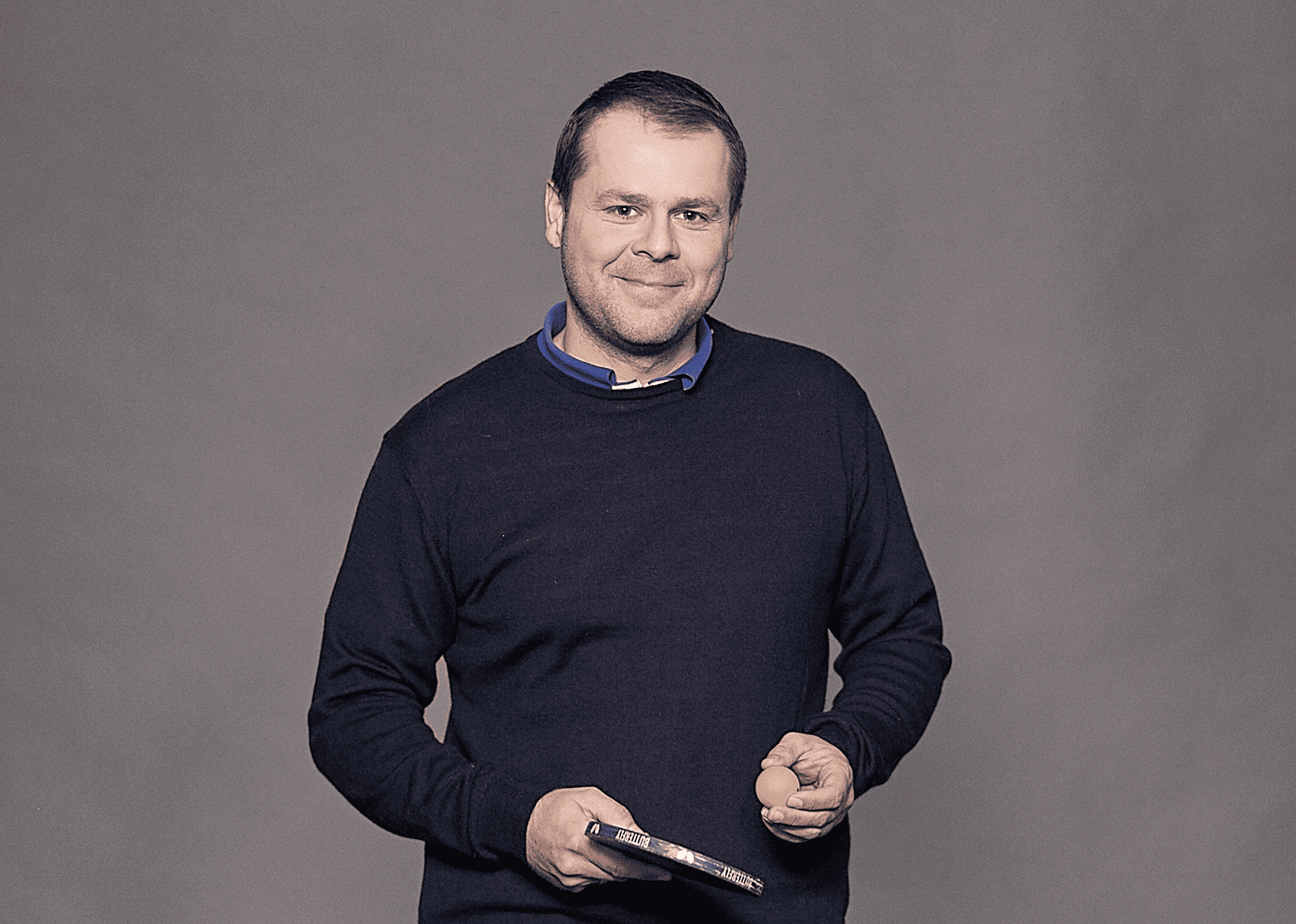 Portrait of smiled Marcin Piela with a palette and a table tennis ball