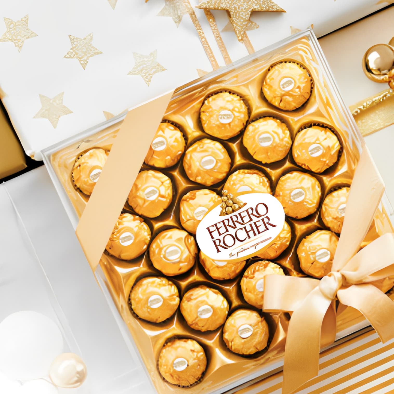A close-up of the Ferrero symbol, which is golden pralines in a transparent elegant box.