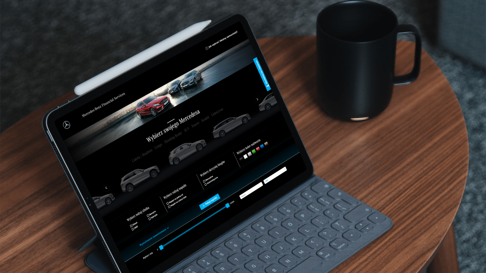 A laptop with a view of the Mercedes car leasing platform, where users can filter cars by drive type, gearbox, or color, among other things, and select a lease installment, the website is black and elegant with blue accent colours